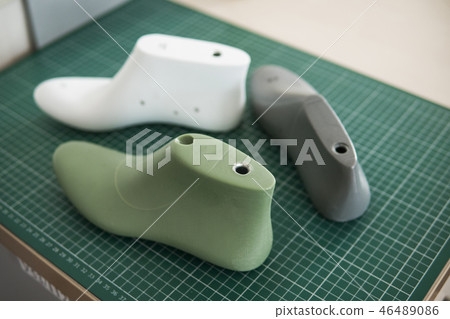 Three plastic last shoe on rubber secondary cut cutting mat, The equipment used for shoe design. Three plastic last shoe on rubber secondary cut cutting mat, The equipment used for shoe design. 46489086