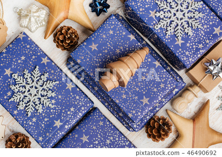 Presents in blue wrapping paper on table 46490692