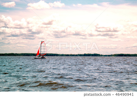 Boat sailing in the lake with a beautiful sky Boat sailing in the lake with a beautiful sky 46490941
