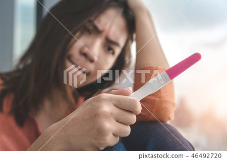 woman holding pregnancy test show negative result 46492720