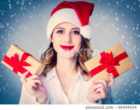 woman in Santa Claus hat with Christmas gift  46494934