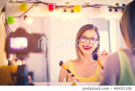 blogger woman applying cosmetics at camera blogger woman applying cosmetics at camera 46495106