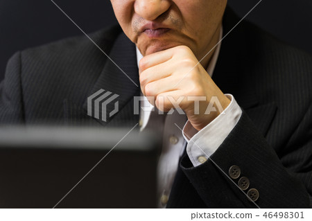 Indecent business man holding a cane and frowning 46498301