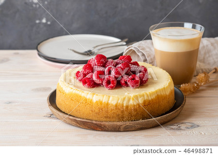 Vanilla New York cheesecake with raspberries and coffee with milk. Copy space. Vanilla New York cheesecake with raspberries and coffee with milk. Copy space. 46498871