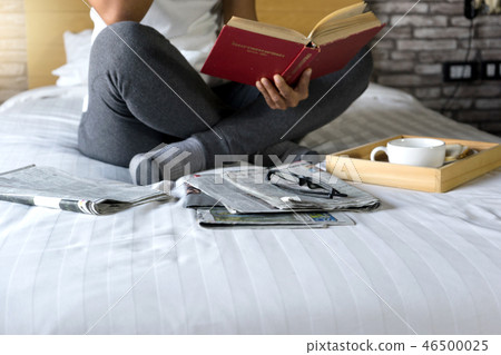 relax woman read a book on the bed relax woman read a book on the bed 46500025