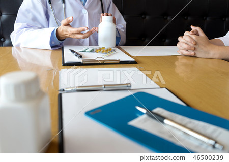 doctor explaining patient symptoms or asking 46500239