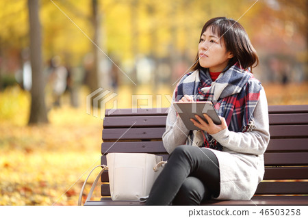 Middle lady enjoying autumn leaves Middle lady enjoying autumn leaves 46503258