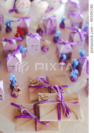 Cute violet decorations for birthday party, sweets and envelopes. Cute violet decorations for birthday party, sweets and envelopes. 46504190
