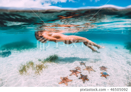Naked woman floating and relax in tropical ocean Naked woman floating and relax in tropical ocean 46505092