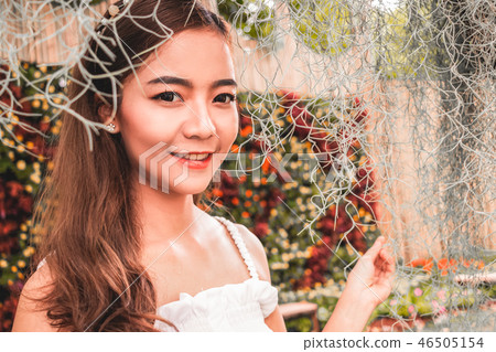 pretty woman smiling on beautiful flowers pretty woman smiling on beautiful flowers 46505154