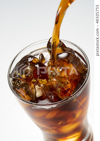 Pour iced coffee into a glass 46505755