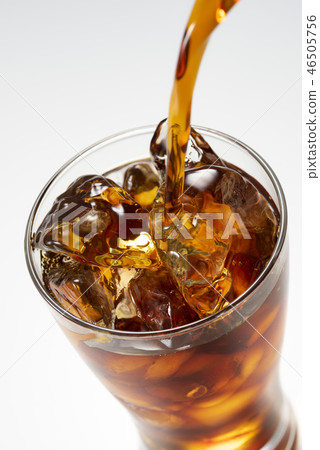 Pour iced coffee into a glass 46505756