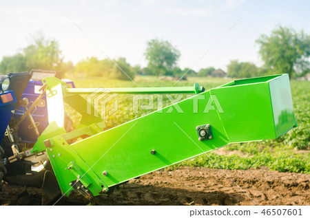 tractor in the field with a plow for digging tractor in the field with a plow for digging 46507601