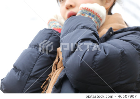 A woman warming her hands A woman warming her hands 46507907