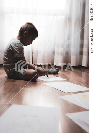 child does his homework, writes and draws 46508309