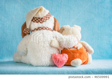Two soft toy dog and rabbit embrace and pink heart Two soft toy dog and rabbit embrace and pink heart 46509991
