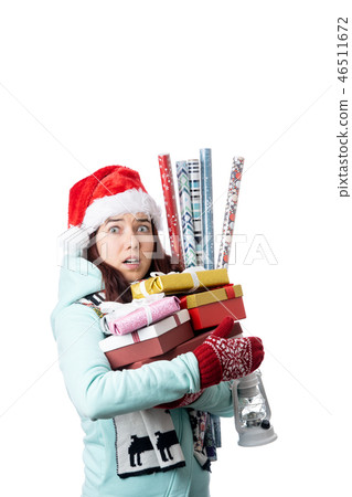 Photo of woman in Santa's cap with boxes with gifts with wrapping paper 46511672