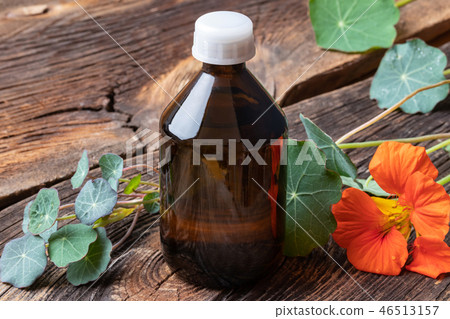 A bottle of nasturtium tincture with fresh plant 46513157
