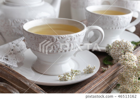 Yarrow tea in white cups with fresh yarrow twigs Yarrow tea in white cups with fresh yarrow twigs 46513162