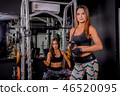 Sexy girl holding dumbbell at gym. 46520095