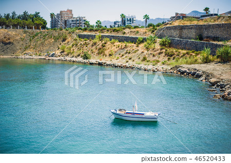 Fishing boat stands in the sea near Kyrenia Castle Fishing boat stands in the sea near Kyrenia Castle 46520433