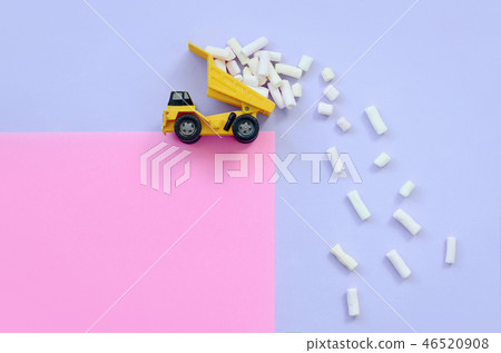 Dump truck throws marshmallow pieces Dump truck throws marshmallow pieces 46520908