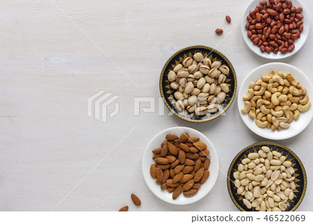 Corner border of fresh nuts in individual bowls Corner border of fresh nuts in individual bowls 46522069