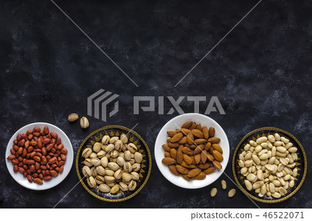 Border with bowls of assorted fresh nuts Border with bowls of assorted fresh nuts 46522071