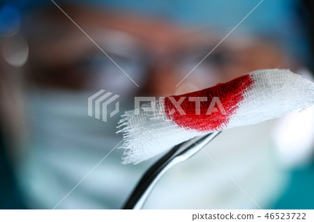 Surgeon in sterile uniform arms holding tools with bio material 46523722