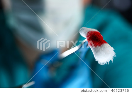 Surgeon in sterile uniform arms holding tools with bio material 46523726