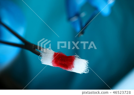 Surgeon in sterile uniform arms holding tools with bio material 46523728