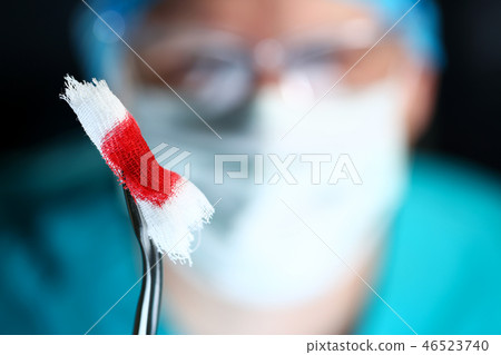 Surgeon in sterile uniform arms holding tools with bio material Surgeon in sterile uniform arms holding tools with bio material 46523740