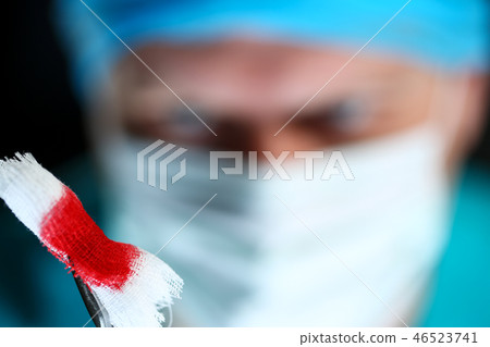 Surgeon in sterile uniform arms holding tools with bio material Surgeon in sterile uniform arms holding tools with bio material 46523741