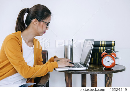Happy casual young asian woman working in home or small office w 46524349