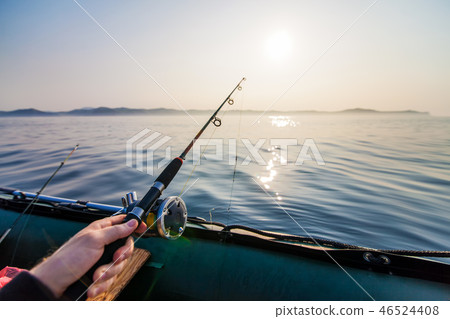Fish-rod in fishermen's hand. 46524408
