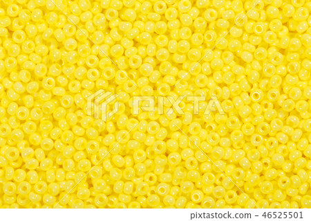 Many yellow glass beads on macro, texture. 46525501
