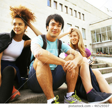 cute group of teenages at the building of university with books cute group of teenages at the building of university with books 46529307