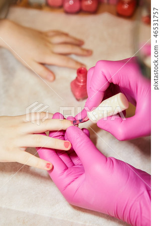 Little girl is getting manicure in beauty salon, close-up. Little girl is getting manicure in beauty salon, close-up. 46531757