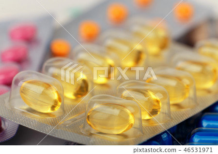 close-up of yellow medical pills in blister 46531971