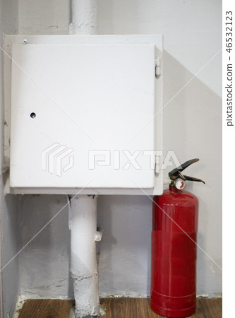 red fire extinguisher near white box with electric red fire extinguisher near white box with electric 46532123