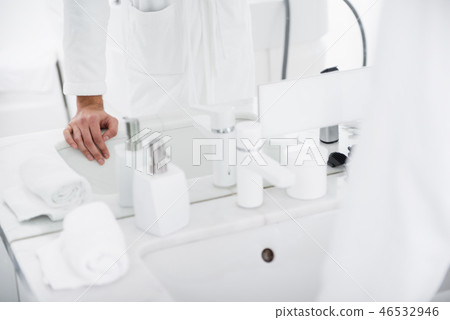 Close up of the sink and person putting hand on it 46532946