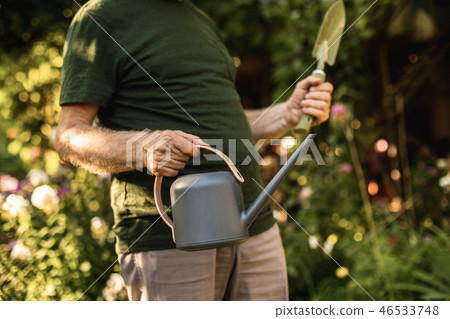 Older gardener going to work in backyard Older gardener going to work in backyard 46533748