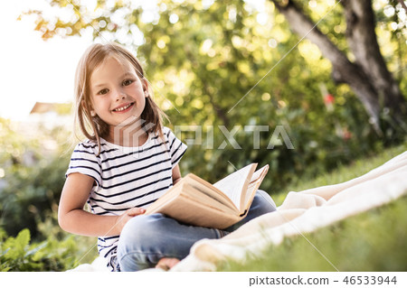 Pretty happy kid resting on mat outside Pretty happy kid resting on mat outside 46533944