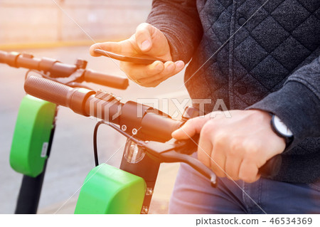 man on an electric scooter paying online 46534369