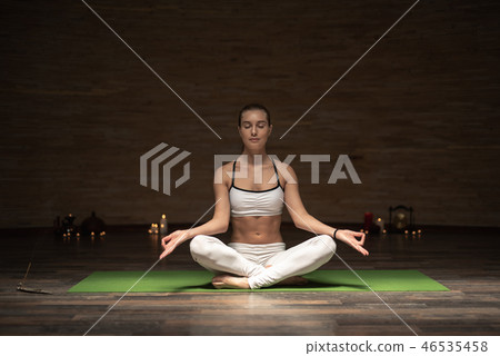 Peaceful lady meditating while being alone with closed eyes Peaceful lady meditating while being alone with closed eyes 46535458