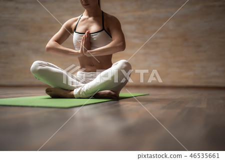 Close up of peaceful lady putting hands to the chest and meditating 46535661