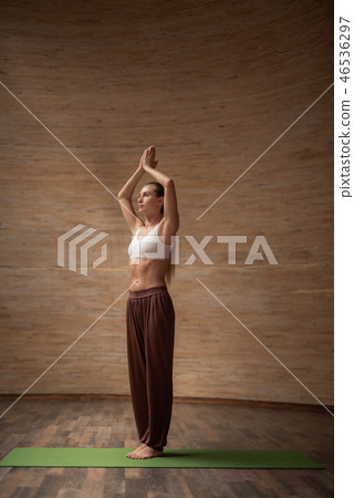 Calm lady putting hands over the head and looking serious 46536297