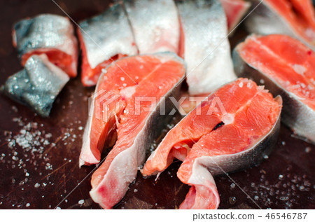 Fresh raw salmon steaks with salt on rustic table 46546787