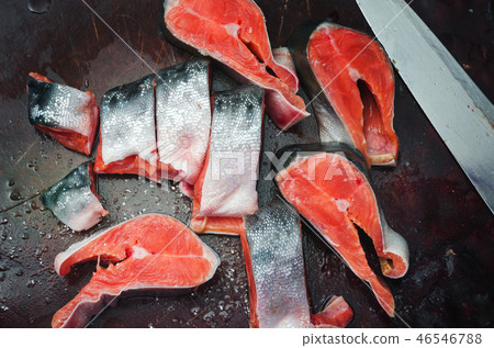 Fresh raw salmon steaks with salt on rustic table Fresh raw salmon steaks with salt on rustic table 46546788