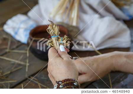 Hands of an elderly woman holding a figure Hands of an elderly woman holding a figure 46548940